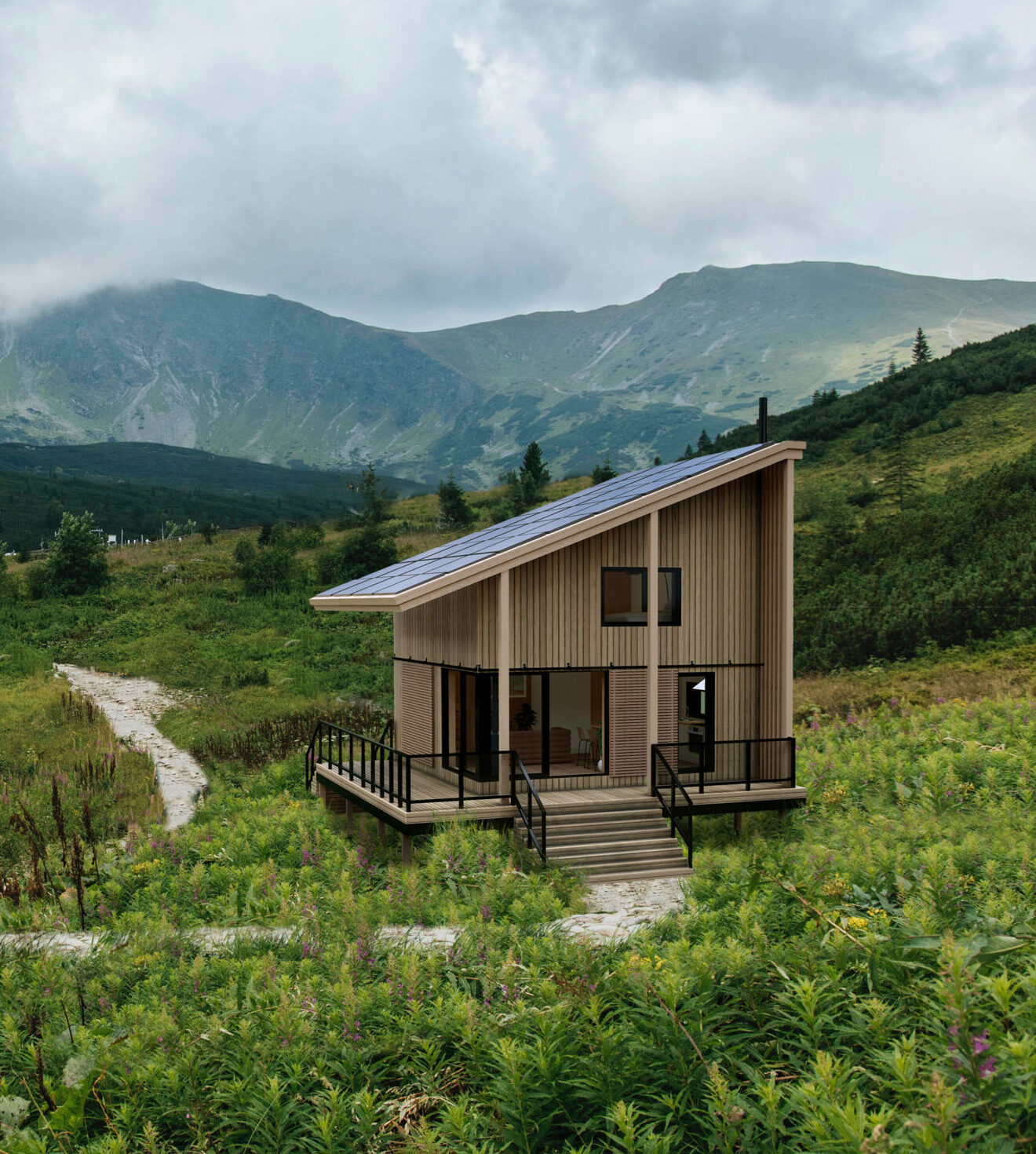 A modern wooden CABN with a sloped roof and solar panels sits along a winding stone path in a lush green mountain valley, with dramatic peaks and low-hanging clouds in the background.